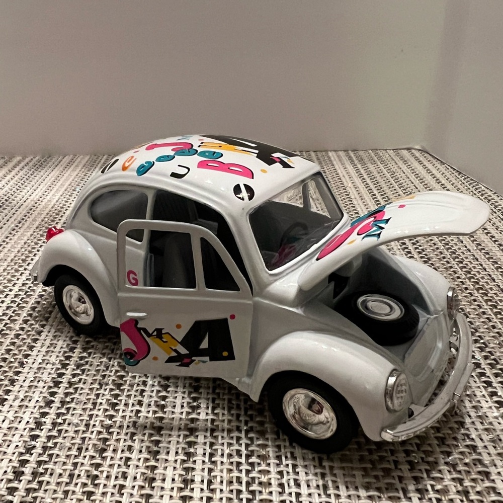 New Volkswagen Beetle with decals Die cast Wheels work with pull back action. 5"